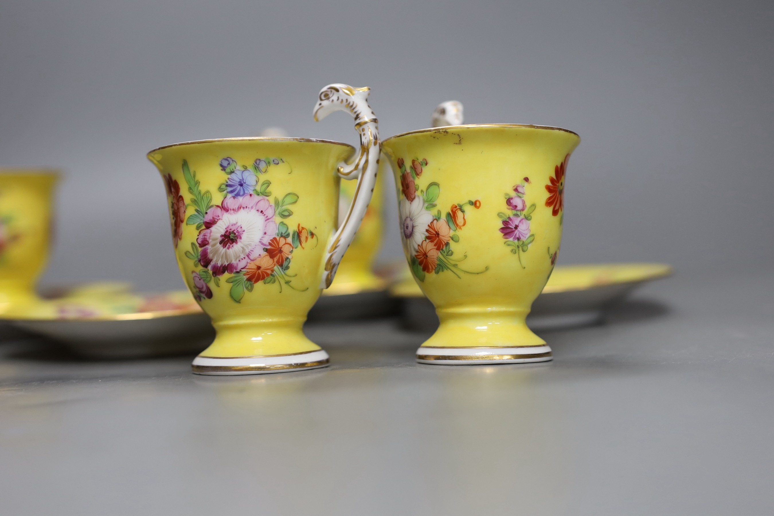 A set of four Dresden yellow ground cups and saucers